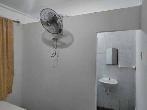 a bathroom with a fan on the wall next to a sink at Indiana Lodge in Santa Clara