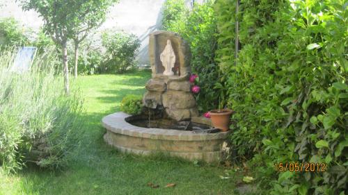 a garden fountain with a statue in a yard at AFFITTACAMERE La Tartaruga in Civitanova Marche