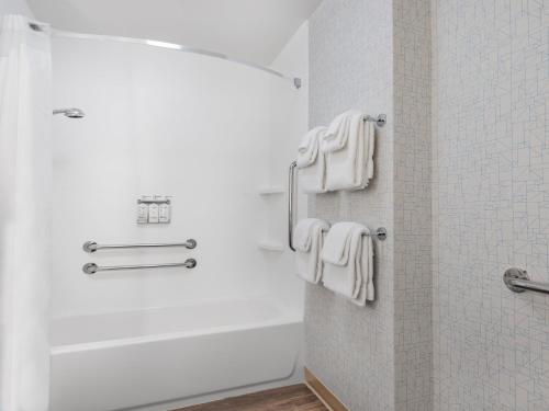 a bathroom with white towels hanging on a wall at Holiday Inn Express & Suites - Ruskin by IHG in Ruskin