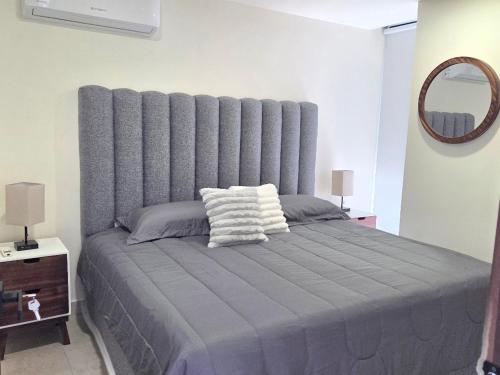 a bedroom with a large bed with a large headboard at Apartment in downtown Zapopan in Guadalajara