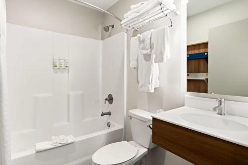 a white bathroom with a toilet and a sink at Holiday Inn Express & Suites George - Quincy South by IHG in George