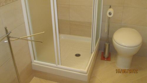 a shower stall in a bathroom with a toilet at AFFITTACAMERE La Tartaruga in Civitanova Marche