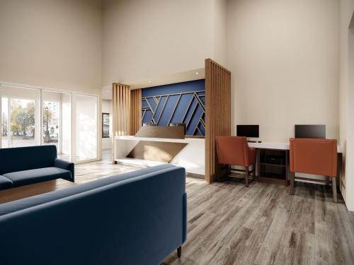 an office with a couch and a desk with a computer at Holiday Inn Express & Suites Southfield - Detroit in Southfield