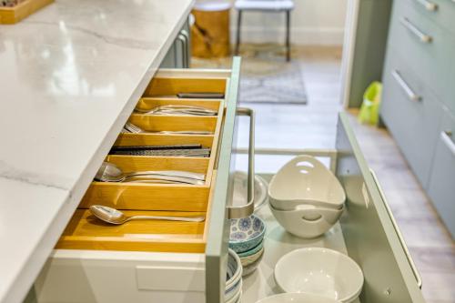 a kitchen with a cabinet filled with dishes at Shambhala Retreat-Zen Suite in Nanoose Bay