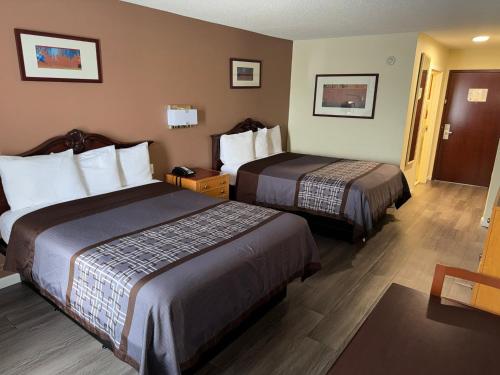 a hotel room with two beds in a room at Scotland Neck Inn in Scotland Neck