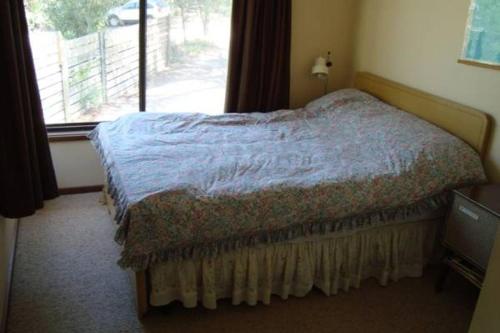 a bedroom with a bed and a window at 40 Aireys Street in Aireys Inlet
