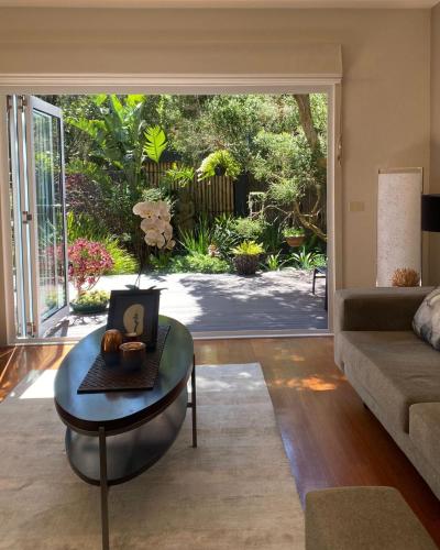 a living room with a table with a clock on it at Aireys Oasis in Aireys Inlet