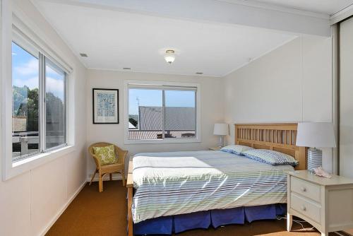 a bedroom with a bed and a window at Mirimar in Apollo Bay
