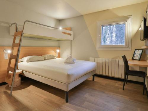 a bedroom with a bunk bed and a desk at Hotel ibis budget Aix Les Bains - Grésy in Grésy-sur-Aix