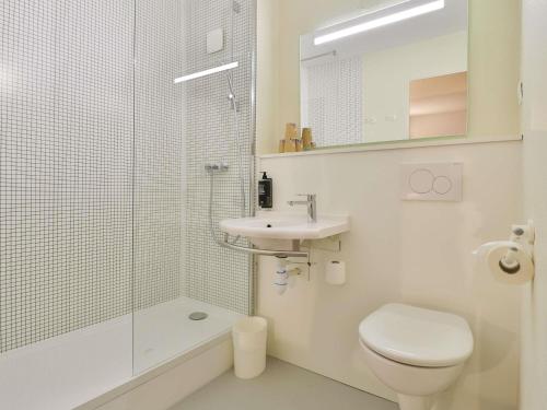 a bathroom with a toilet and a sink and a shower at Hotel ibis budget Aix Les Bains - Grésy in Grésy-sur-Aix