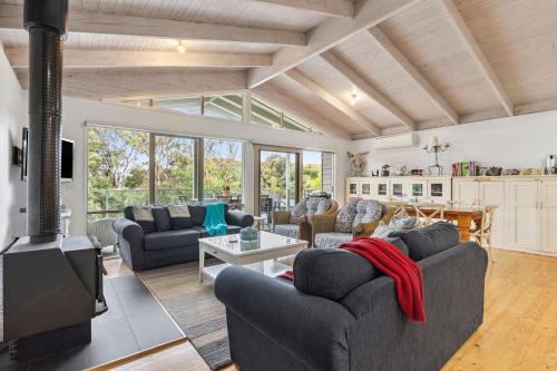 a living room with couches and a fireplace at Coastwalk in Aireys Inlet