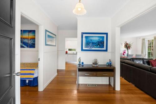 a living room with a couch and a table at Noble Villa - BYO Linen in Anglesea