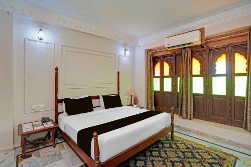 a bedroom with a large bed and a window at Palette Hotel and Resorts Jodhpur Airport Formerly Royale Plazo in Jodhpur