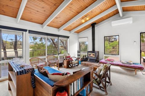 a living room with a couch and a fireplace at Fairhaven Escape in Aireys Inlet