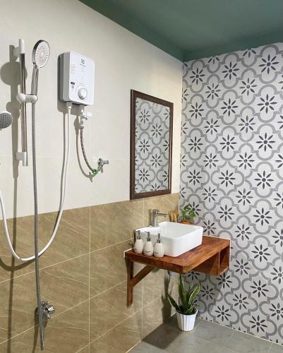 a bathroom with a shower and a sink at Xóm Chài Homestay in Thôn Sơn Hải