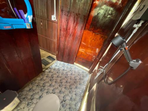 a small bathroom with a toilet in a room at Nam Binh Homestay in Ben Tre