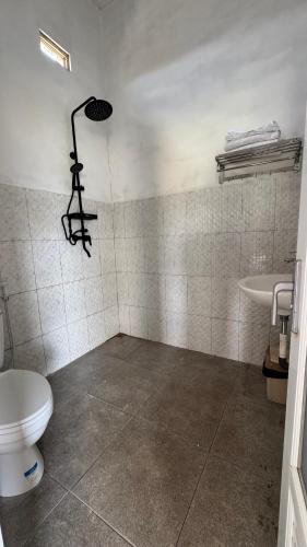a bathroom with a toilet and a sink at Payas Private Farm Villa in Praya