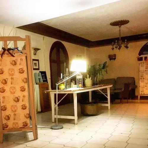 a room with a table with a lamp on it at Hostal Pirineos in Barbastro