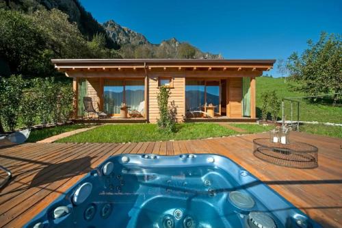 a hot tub on a deck in front of a house at Agriturismo Serec in Angolo Terme