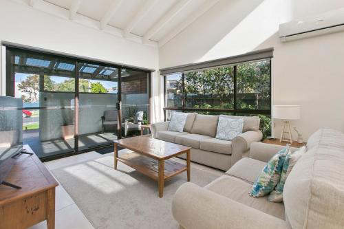 a living room with a couch and a table at Beachside Villa in Apollo Bay