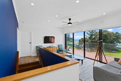 an open living room with a view of a balcony at Casino Views in Apollo Bay