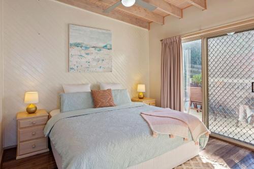 a bedroom with a bed and a large window at Otway Views in Apollo Bay
