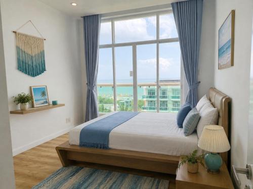 a bedroom with a bed with a large window at Ocean Vista Mai House in Ấp Phú Tịnh (2)