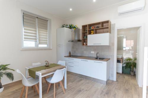 a kitchen and dining room with a table and chairs at Ramo D'oro Relax Apartments in Ariccia