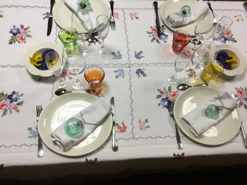 a table with plates and glasses on a table at Hostal Pirineos in Barbastro