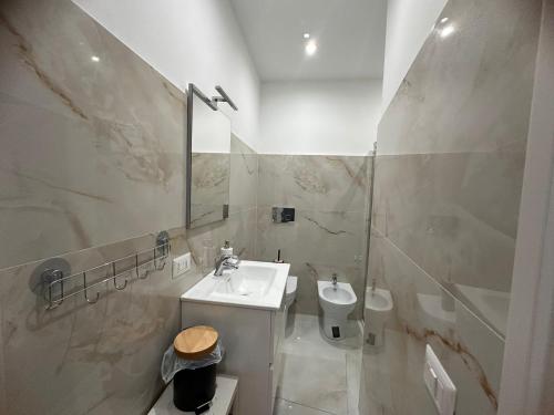 a white bathroom with a sink and a toilet at Casa Vacanza - PERLA MARINA- 40 mt dal mare in Crotone
