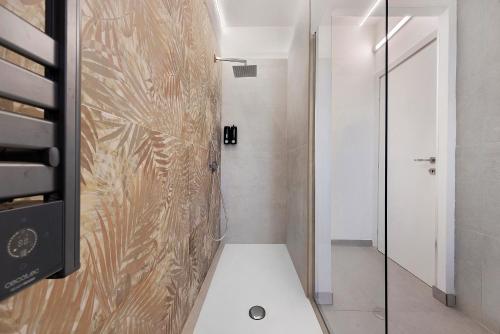 a bathroom with a shower with a glass door at Sicilian Sea Breeze - Apartment in Bagheria