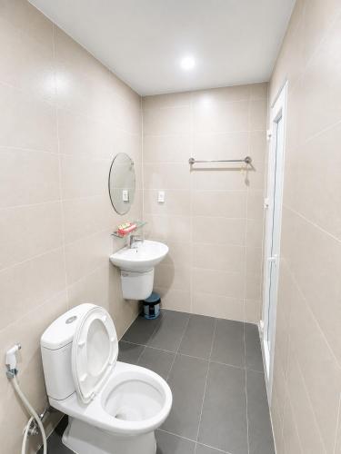 a bathroom with a toilet and a sink at LUNA Hotel in Ho Chi Minh City