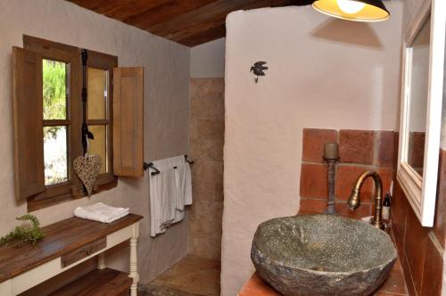 a bathroom with a large stone sink in a room at Auberge U Sirenu in Sartène