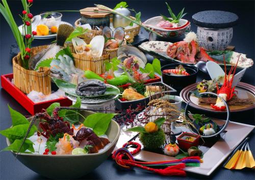 a table with many plates of food on it at 旅館かわな -Ryokan Kawana- in Kimitsu