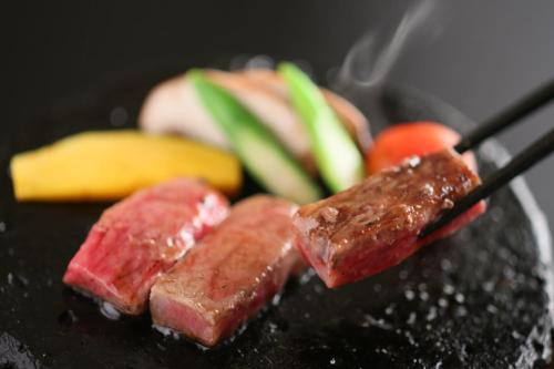 a plate of food with meat and vegetables on it at 旅館かわな -Ryokan Kawana- in Kimitsu