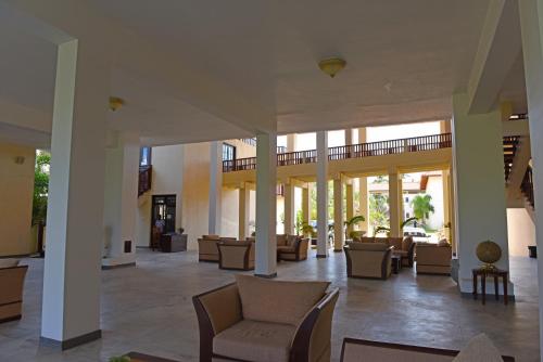 a lobby with couches and chairs in a building at Marina Beach Passikudah in Pasikuda