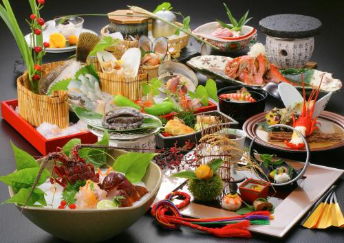 a table with many plates of food on it at 旅館かわな -Ryokan Kawana- in Kimitsu