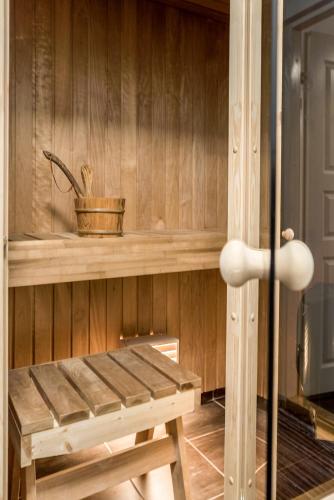 a sauna with a bench and a plant on a shelf at Marja Apartment in Põltsamaa