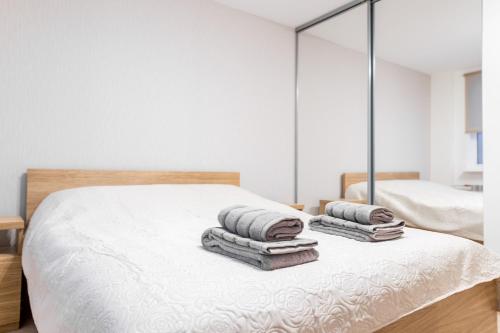 a bedroom with a bed with towels on it at Marja Apartment in Põltsamaa