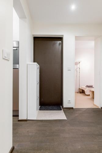 an open door in a room with a refrigerator at Marja Apartment in Põltsamaa