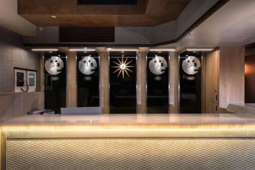 a room with clocks on the wall and a counter at Sunrise Hotel in Chiayi City