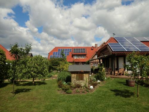 a house with solar panels on the roof at The Cosy Home in Hodenhagen