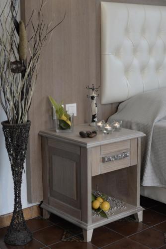 a small table with fruit on it in a room at Olivegrove House in Vourvourou