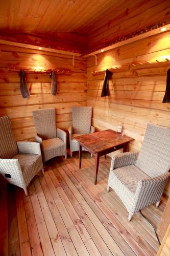 a room with chairs and a table in a cabin at Metsara B & B in Tornimäe