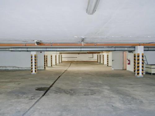 a large room with yellow and white poles in a building at Belvárosi Panzió in Debrecen