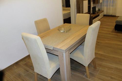a dining room table with four chairs and a table and chairsktop at Ferienwohnungen Tannenhof in Steinen
