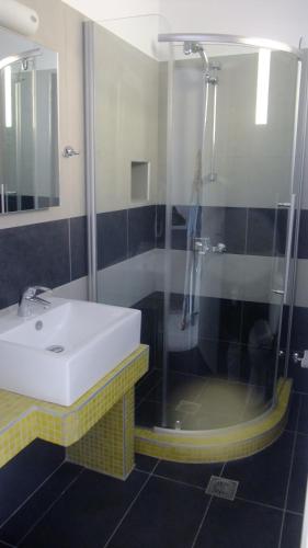 a bathroom with a sink and a shower at Villa Valvis in Perissa