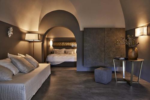 a bedroom with a bed with an archway in it at Sikelia Luxury Hotel in Pantelleria