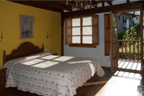 a bedroom with a bed and a window at Casa Rural La Torre de Espinama in Espinama