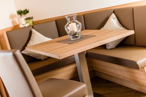 a small table in a booth in a restaurant at Astor Hotel in Schenna